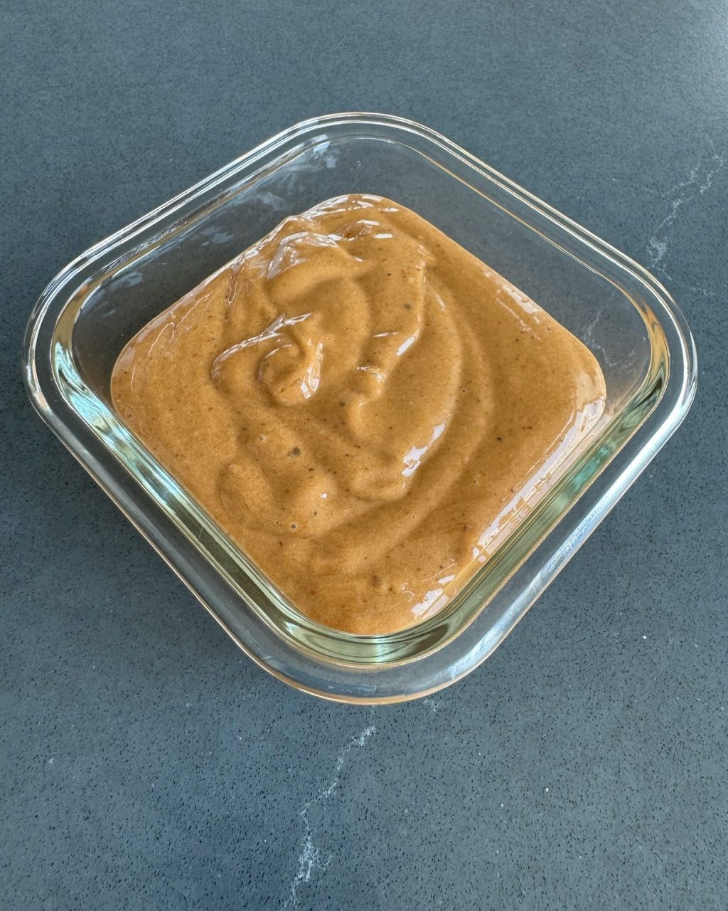 Glass dish of creamy tan black garlic habanero aioli