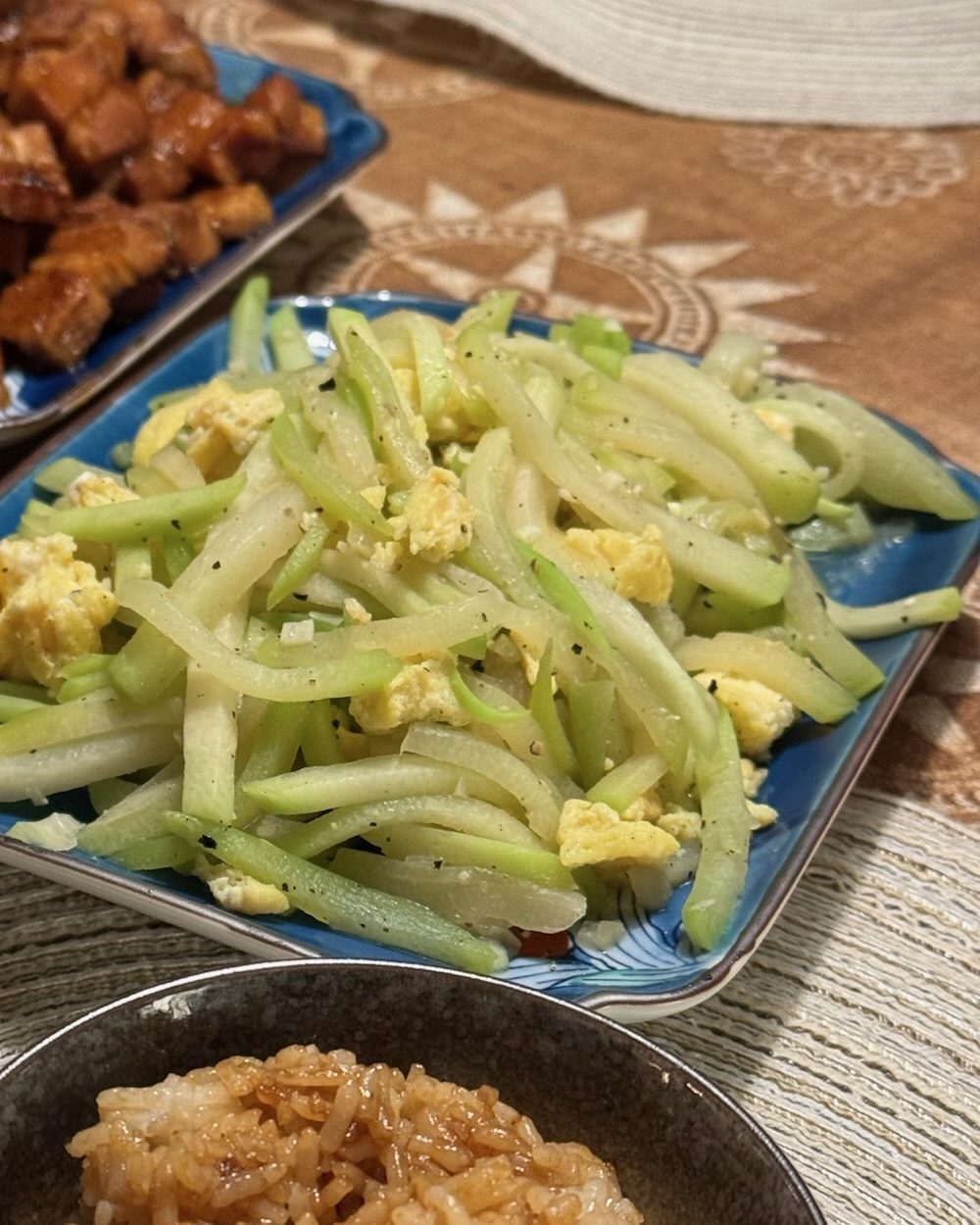 Chayote squash matchsticks stir-fried with chunks of scrambled egg on a plate